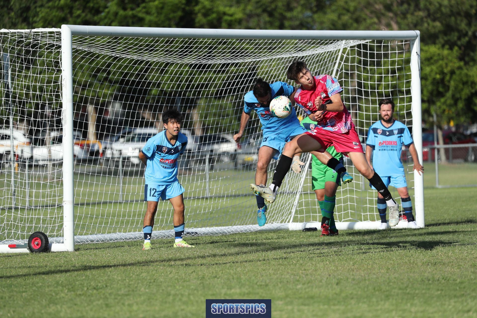 tweed united footballer heading the ball off the goal line