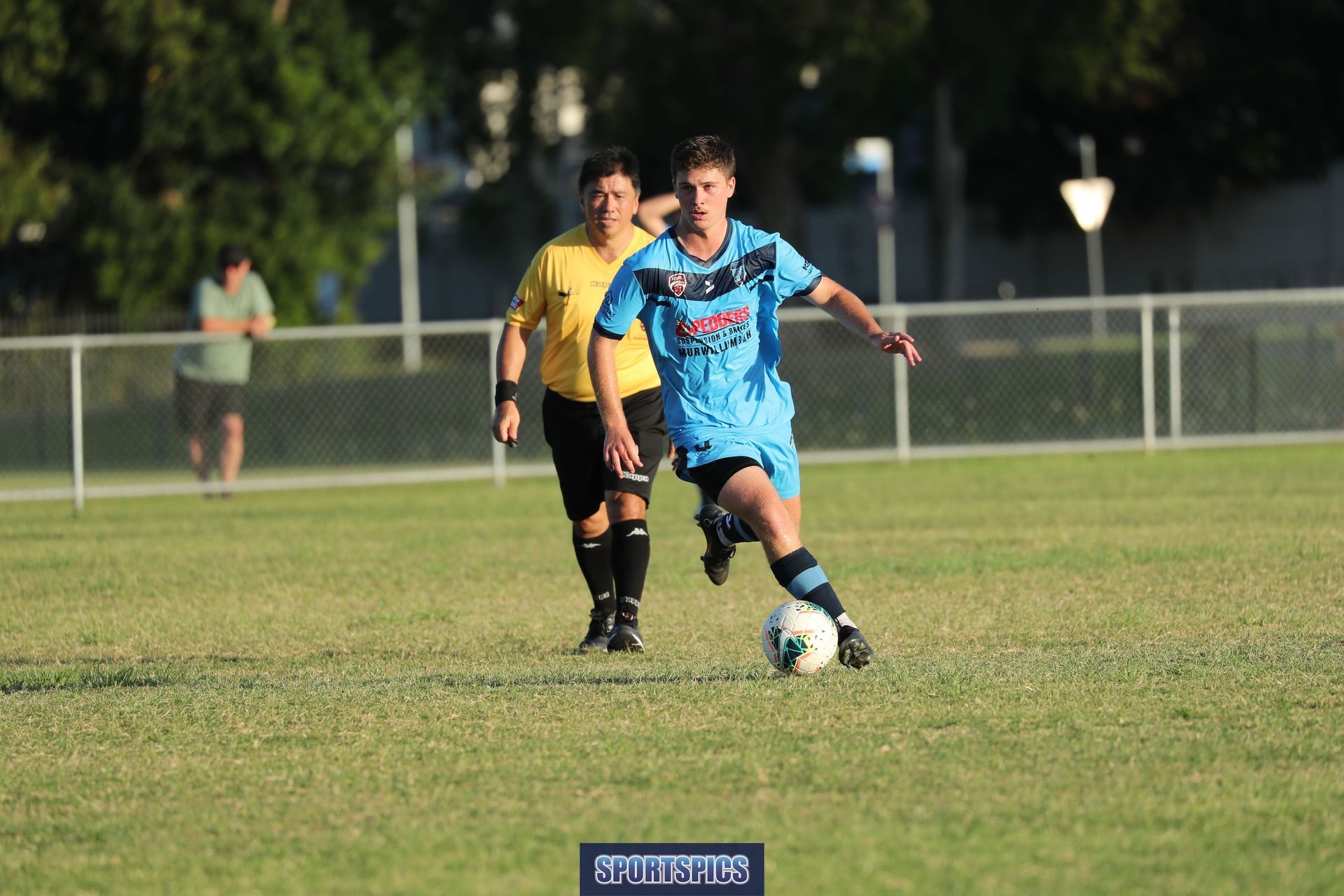 tweed united footballer running with ball