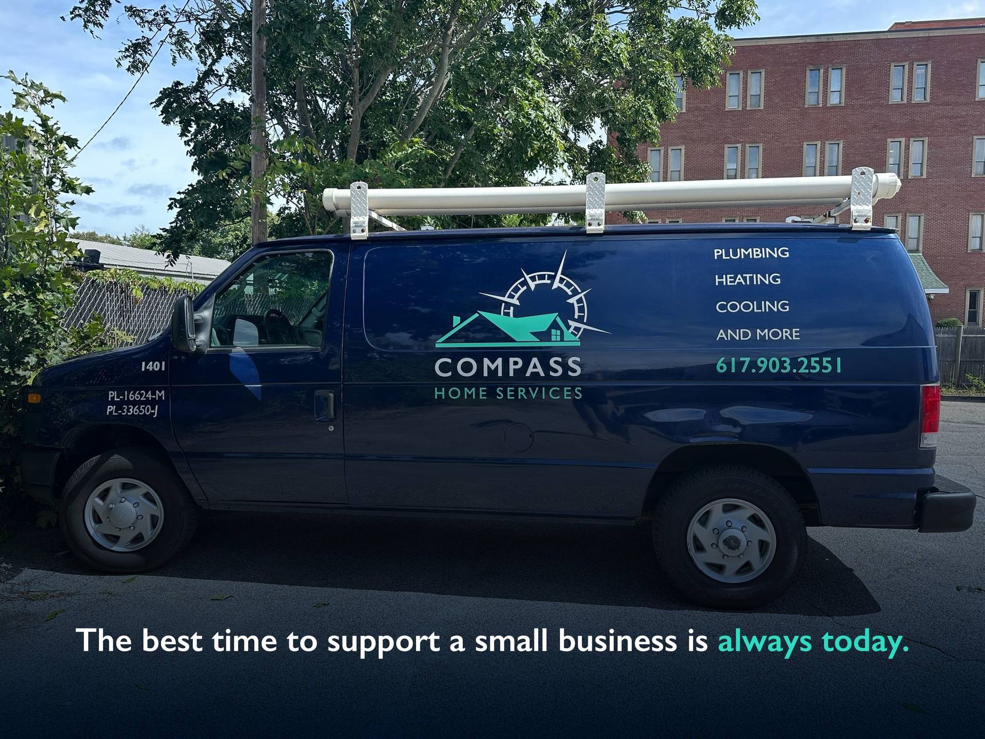A compass van is parked in front of a building
