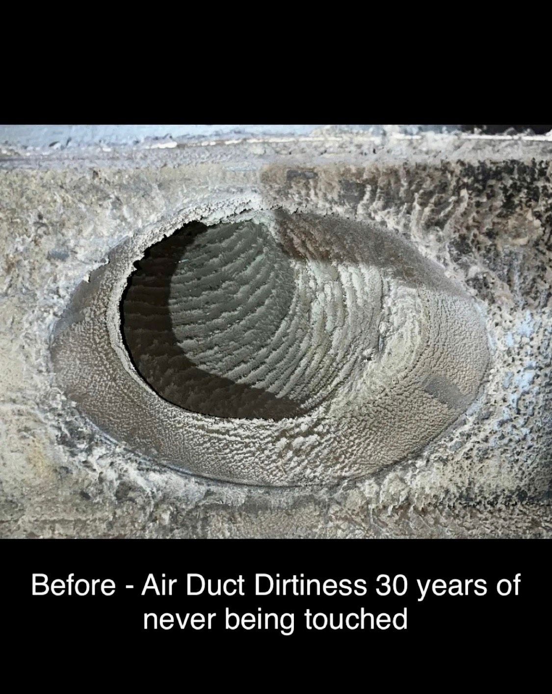 A circular metal air duct coated in a thick layer of grey dust and debris after 30 years of neglect.