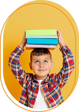 A young boy is holding a stack of books on his head.