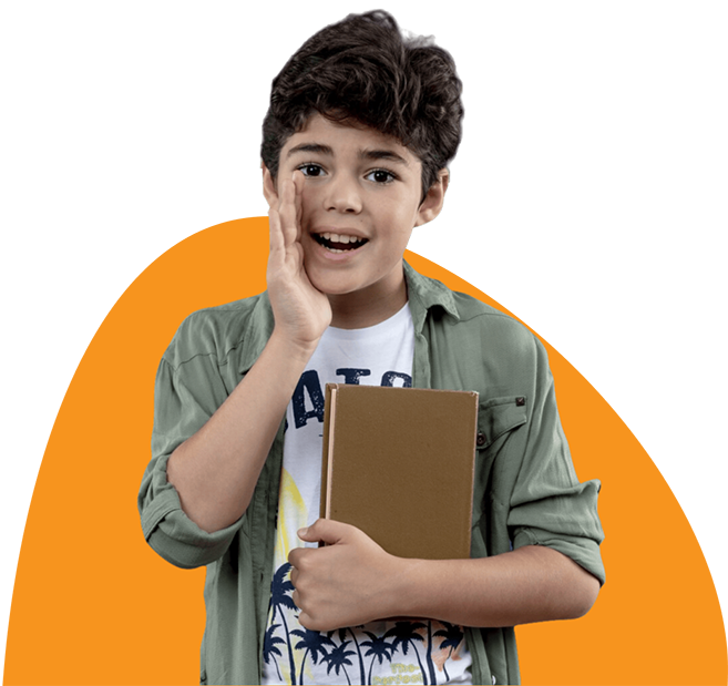 A young boy is holding a book and smiling.