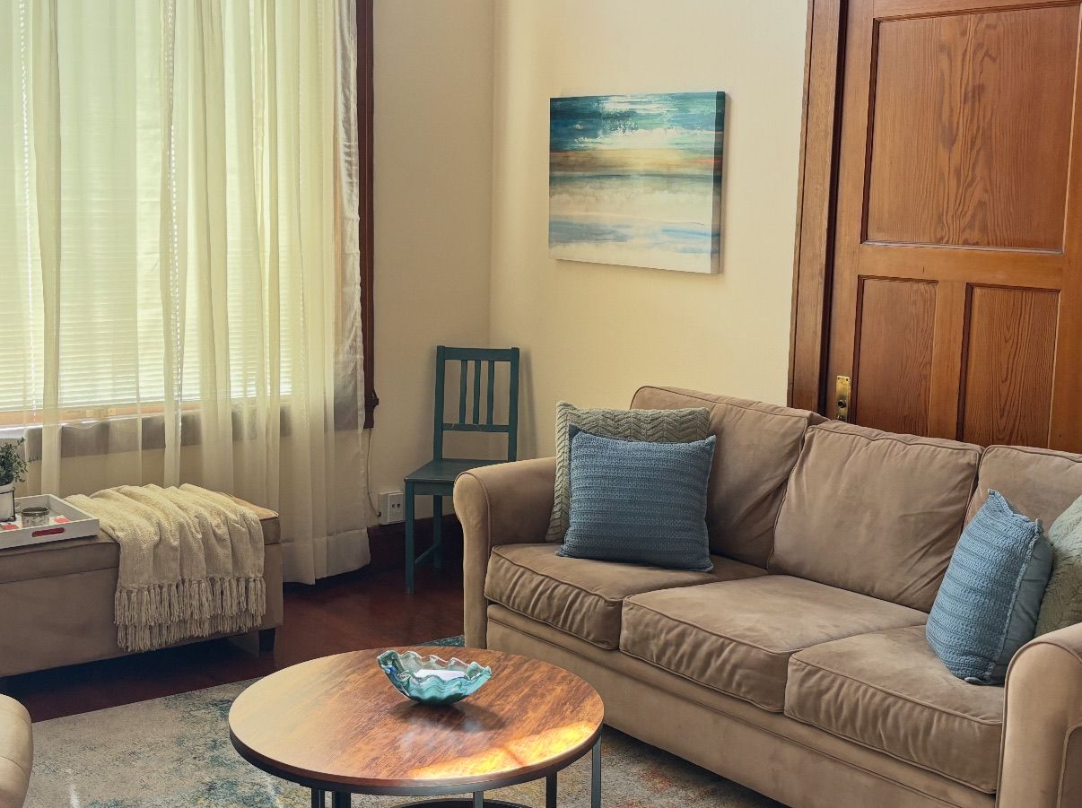 A living room with a couch a chair and a coffee table