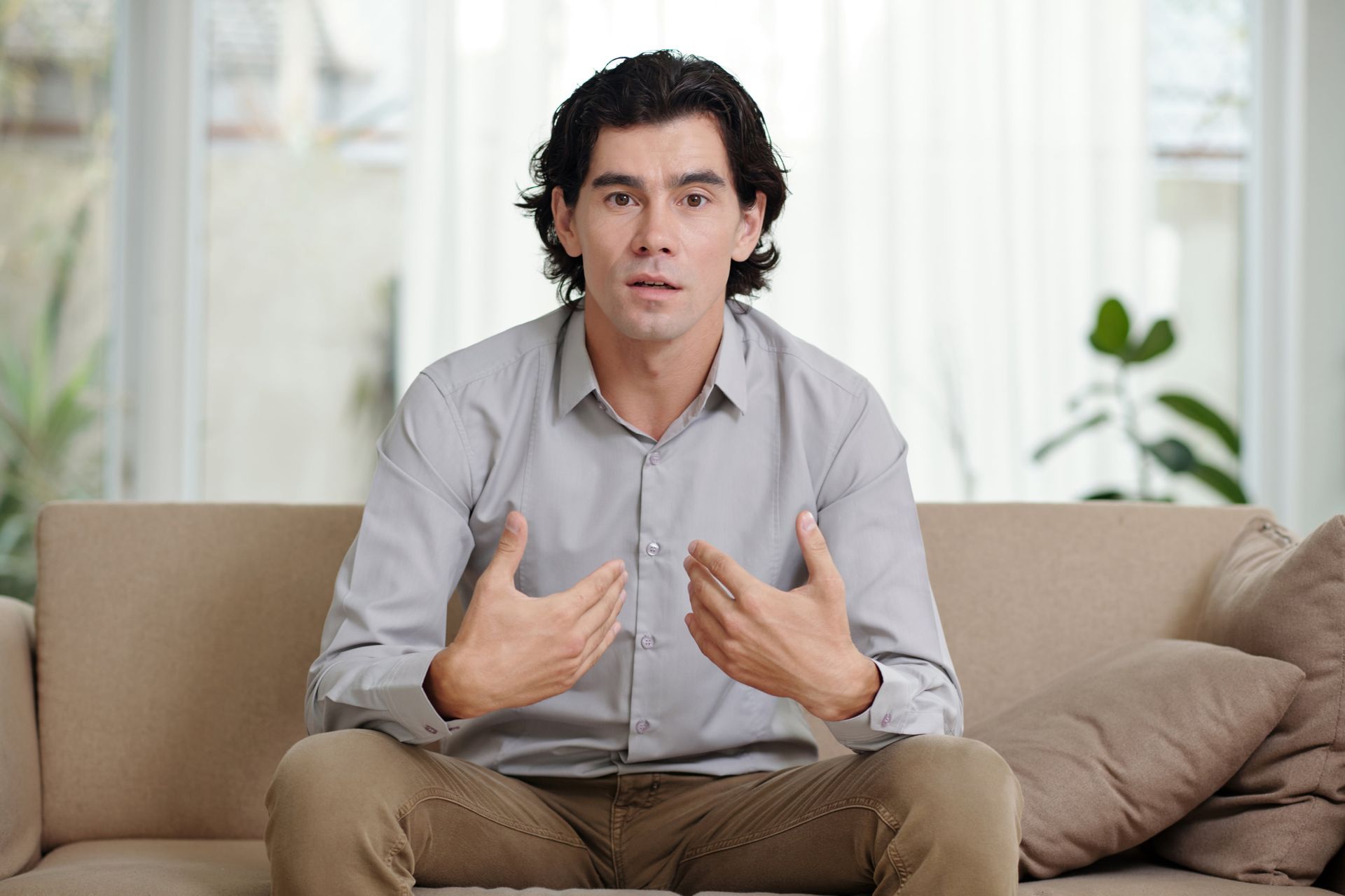 A man and a woman are sitting on a couch having an argument.