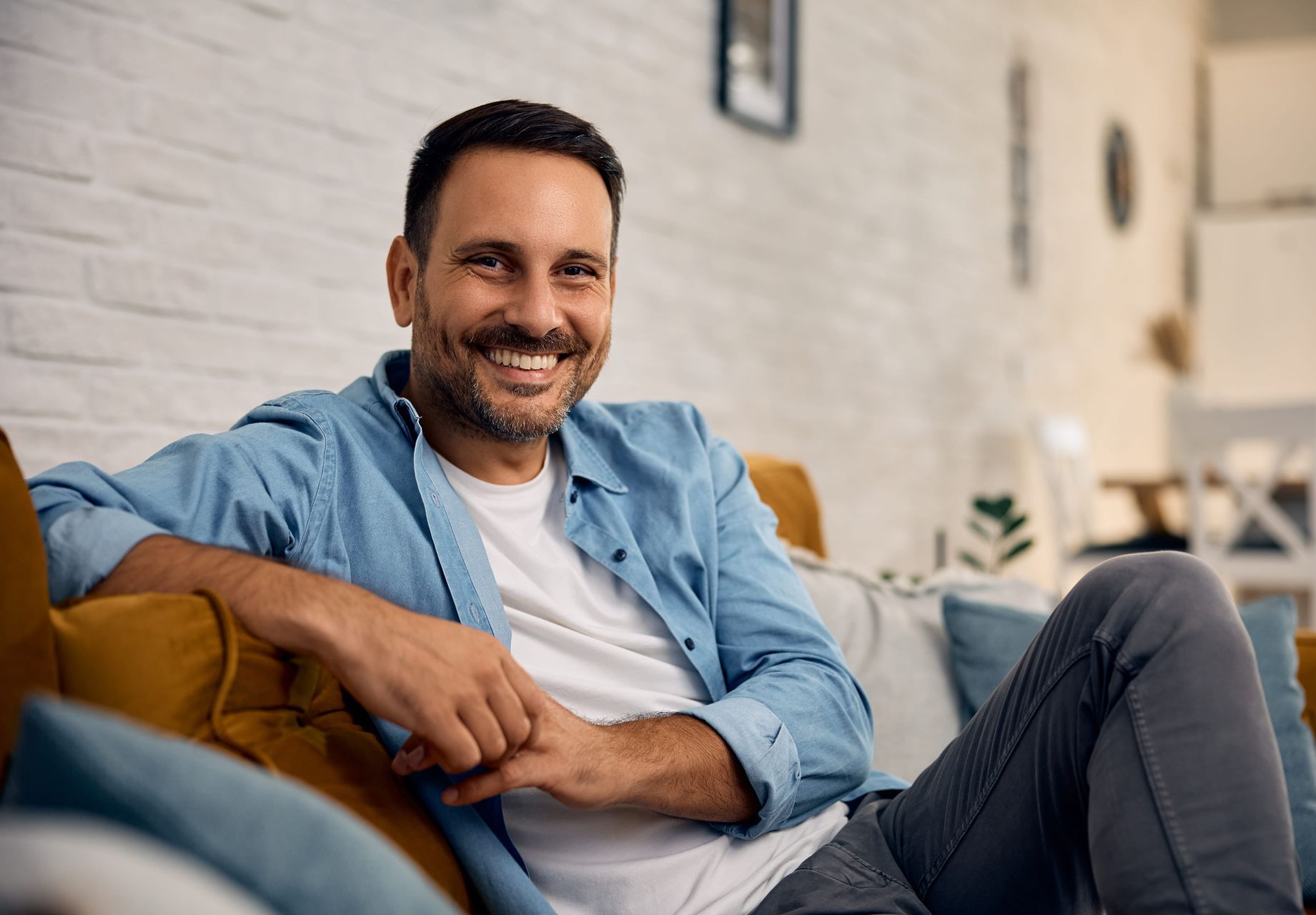 A man and a woman are sitting on a couch talking to a therapist.