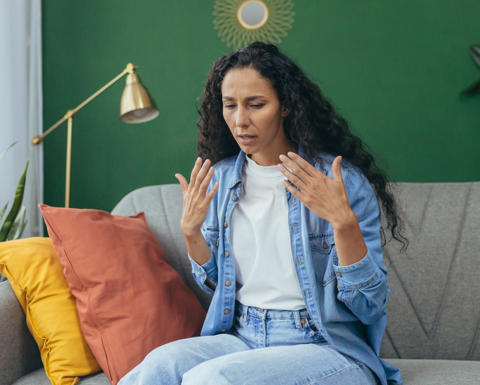 A man and a woman are sitting on a couch having an argument.