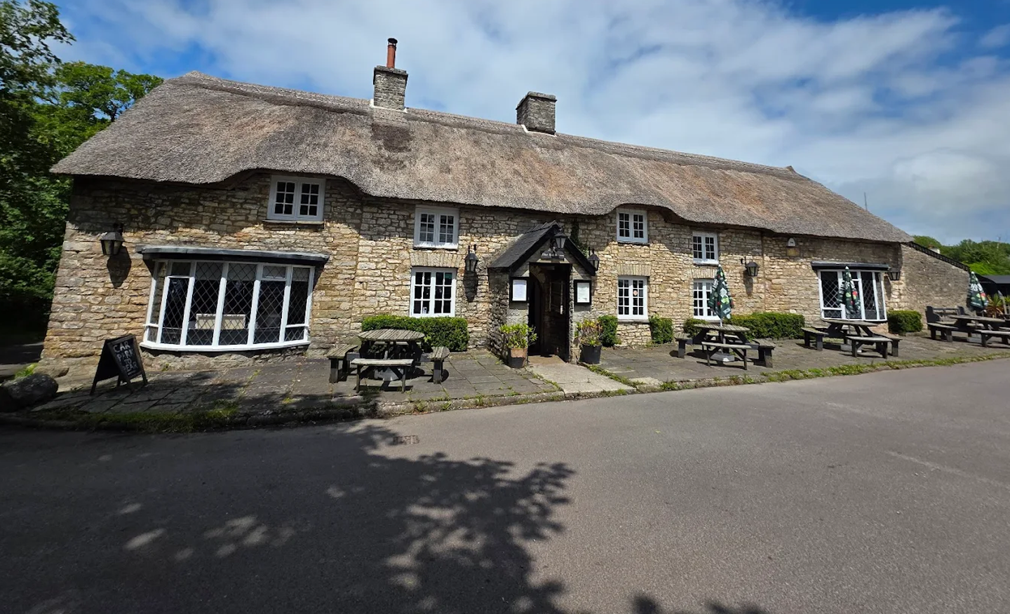 The historic thatched exterior of The Bush Inn in St Hilary, Vale of Glamorgan.