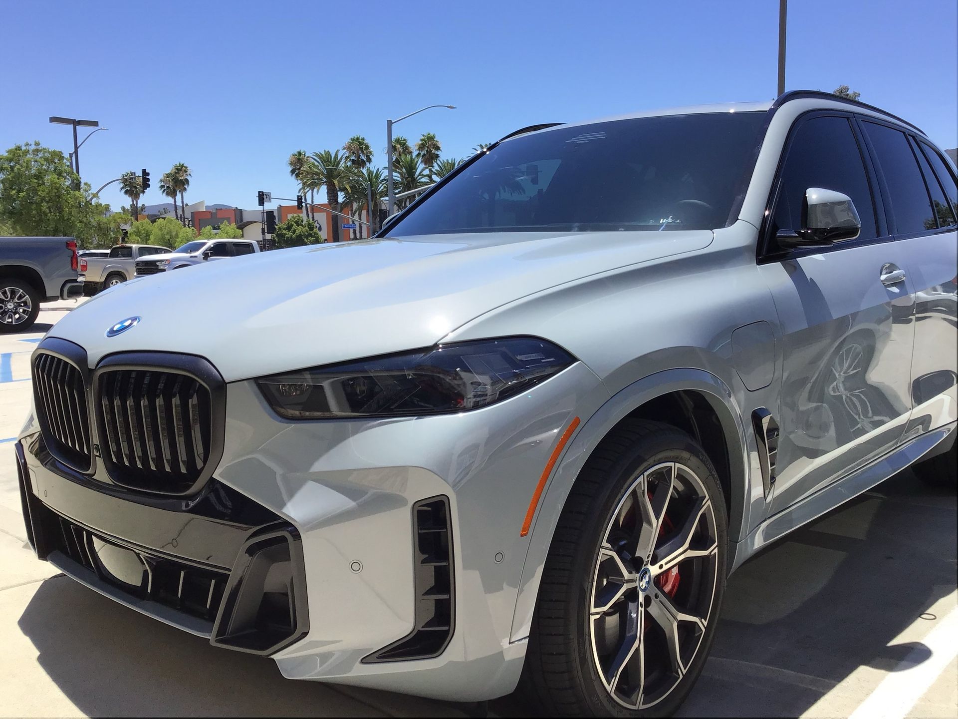 A grey bmw x5 is parked in a parking lot