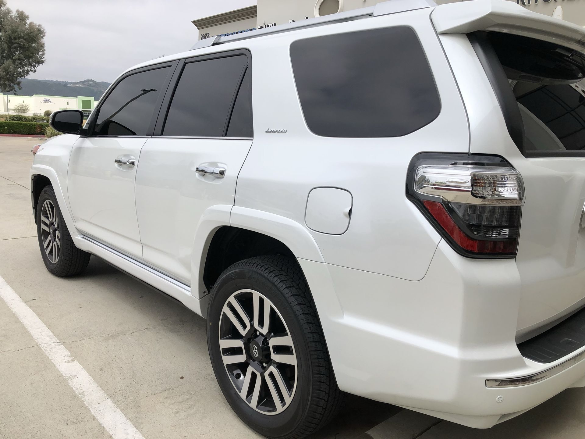 A white suv is parked in a parking lot.