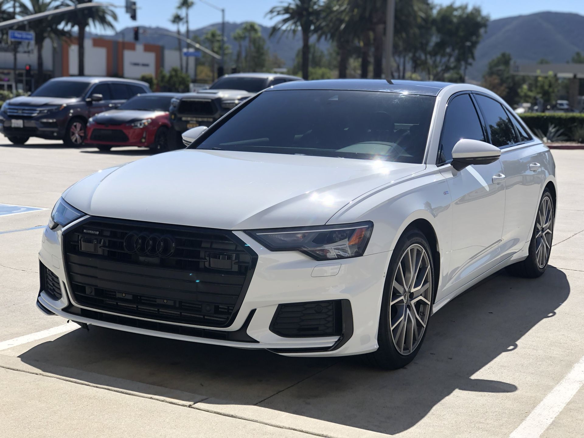 A grey bmw x5 is parked in a parking lot