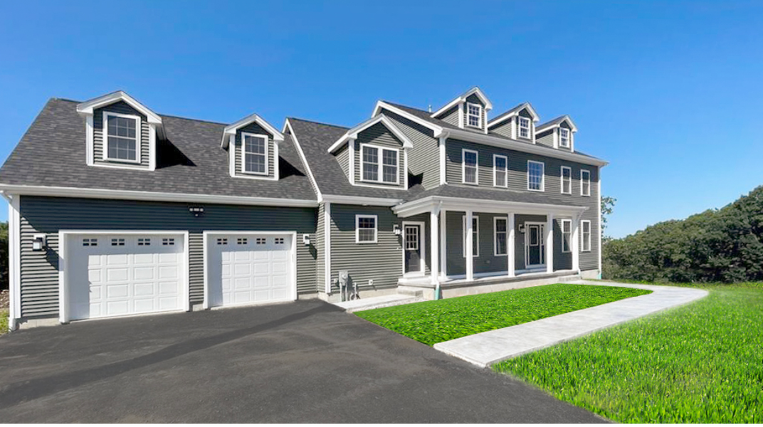 Gray two-story house with a two-car garage, a long front porch, and a paved driveway, set against a blue sky.