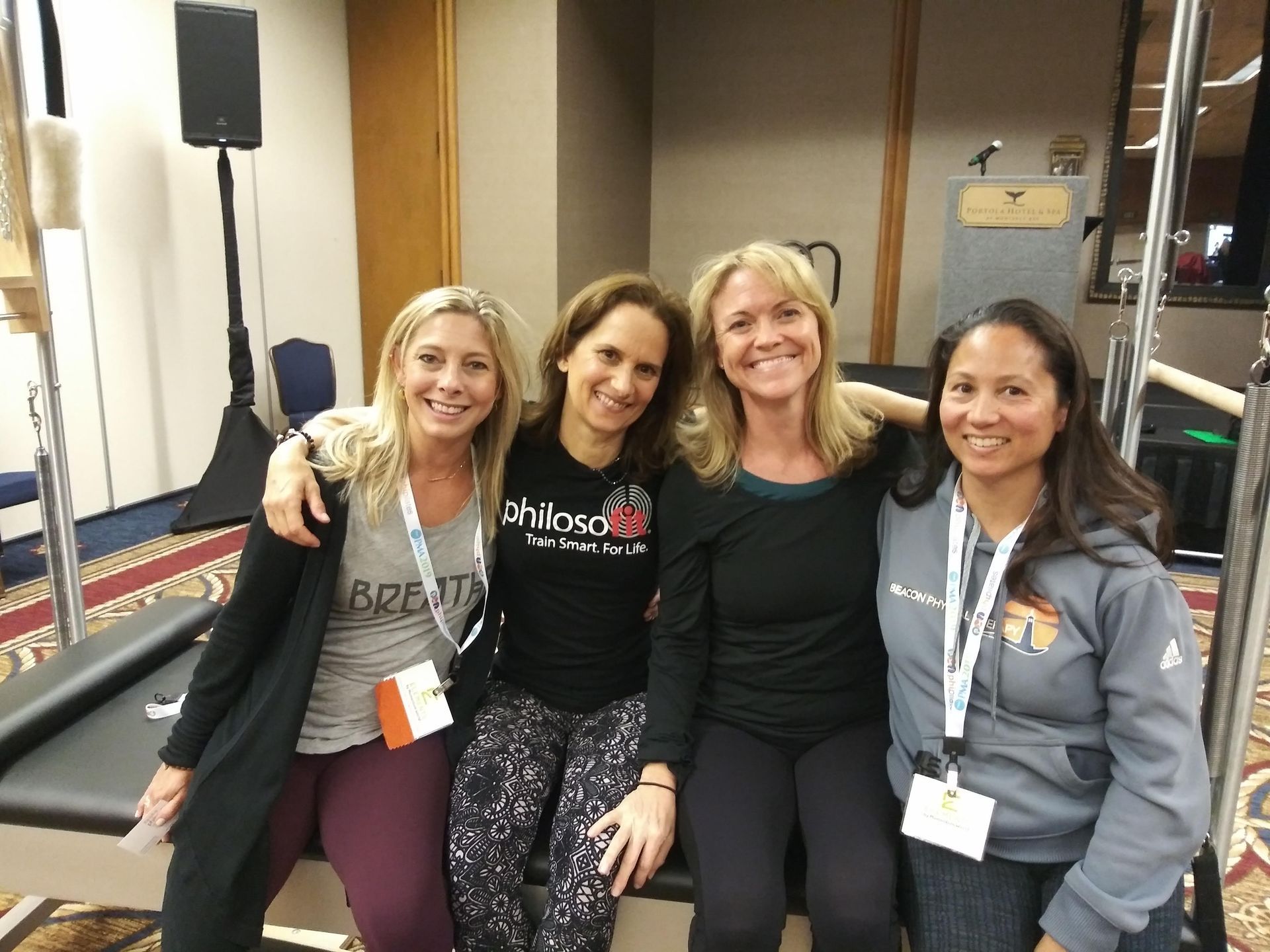 A group of women are posing for a picture in a room.