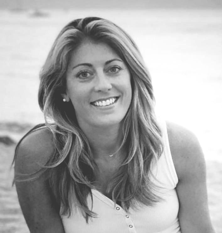 Andra with long hair is smiling in a black and white photo .