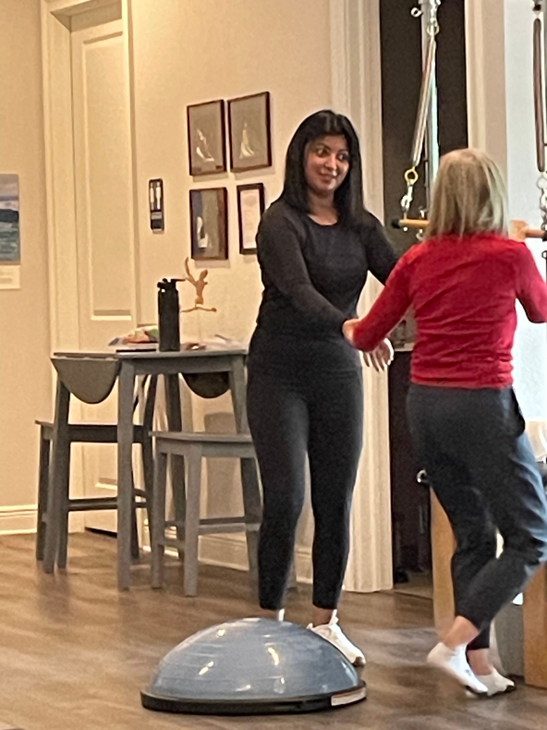 Two women are standing next to each other in a room.