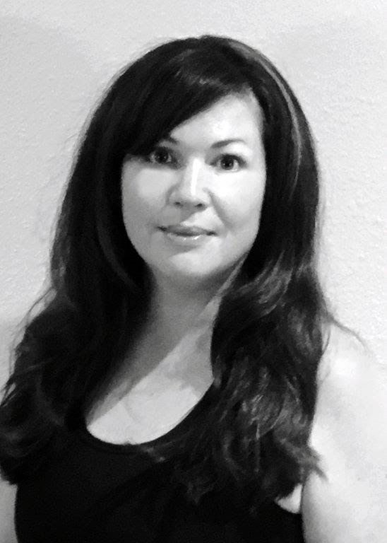 A black and white photo of a woman with long hair wearing a black tank top.