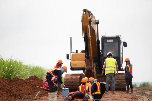 A group of construction workers are working on a construction site.