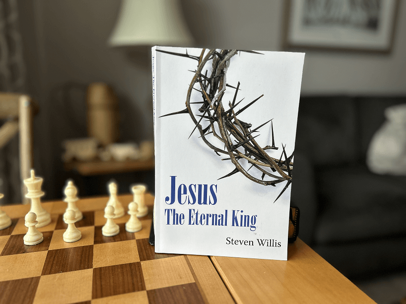 A book titled jesus the eternal king sits on a chess board
