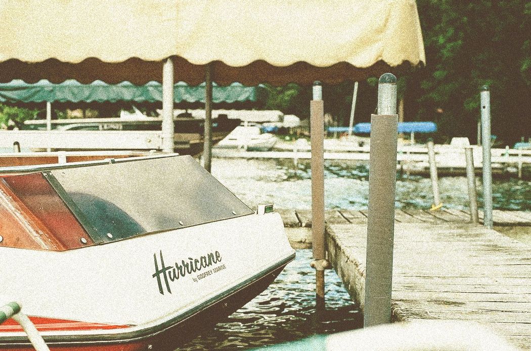 A boat named hurricane is docked at a dock