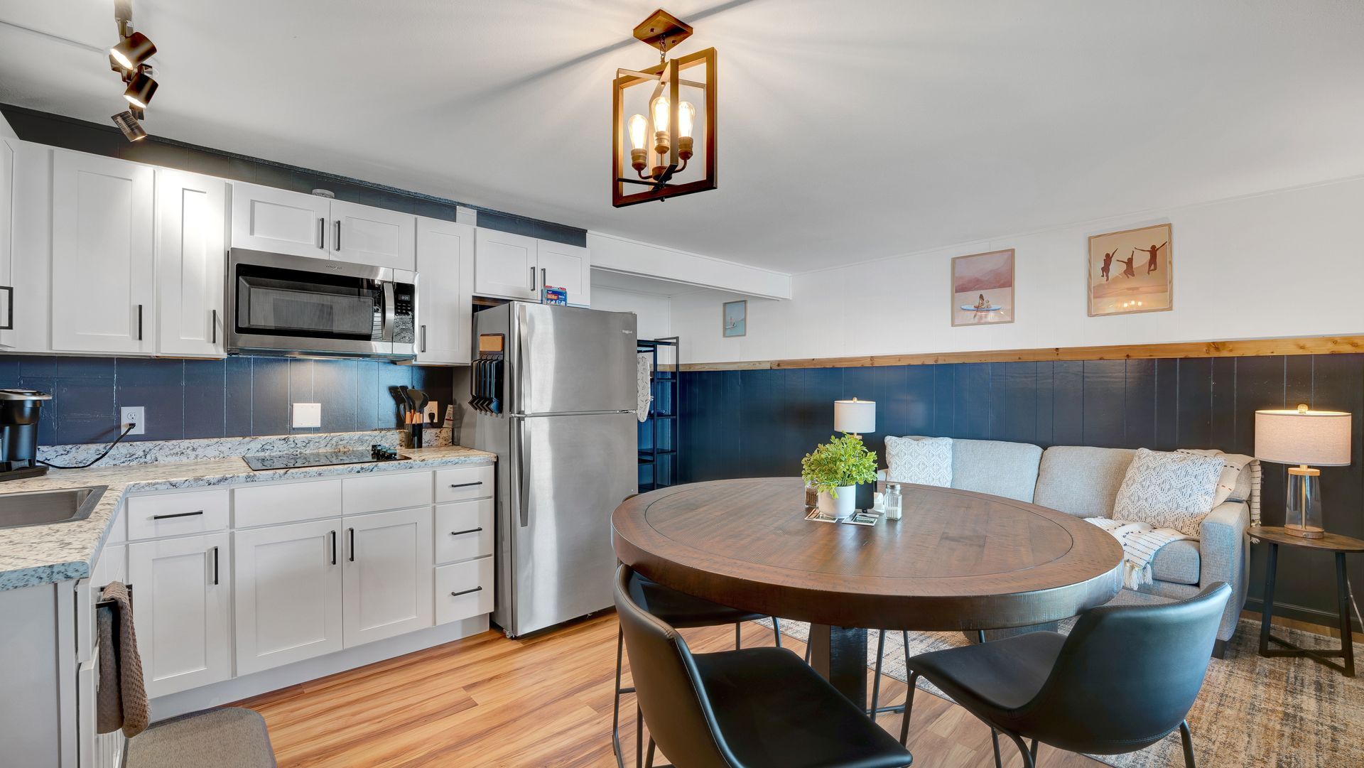 A kitchen and dining room in a house with a table and chairs.