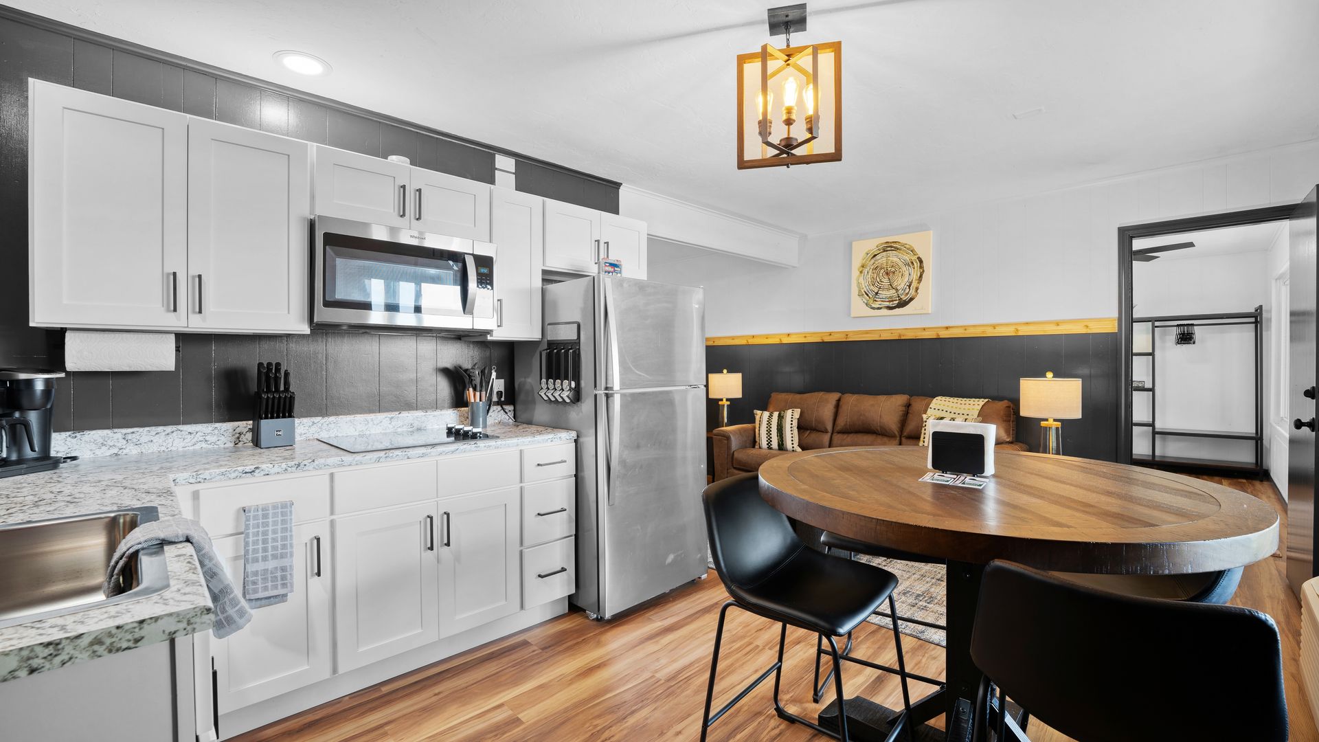 A kitchen with a table and chairs in it.