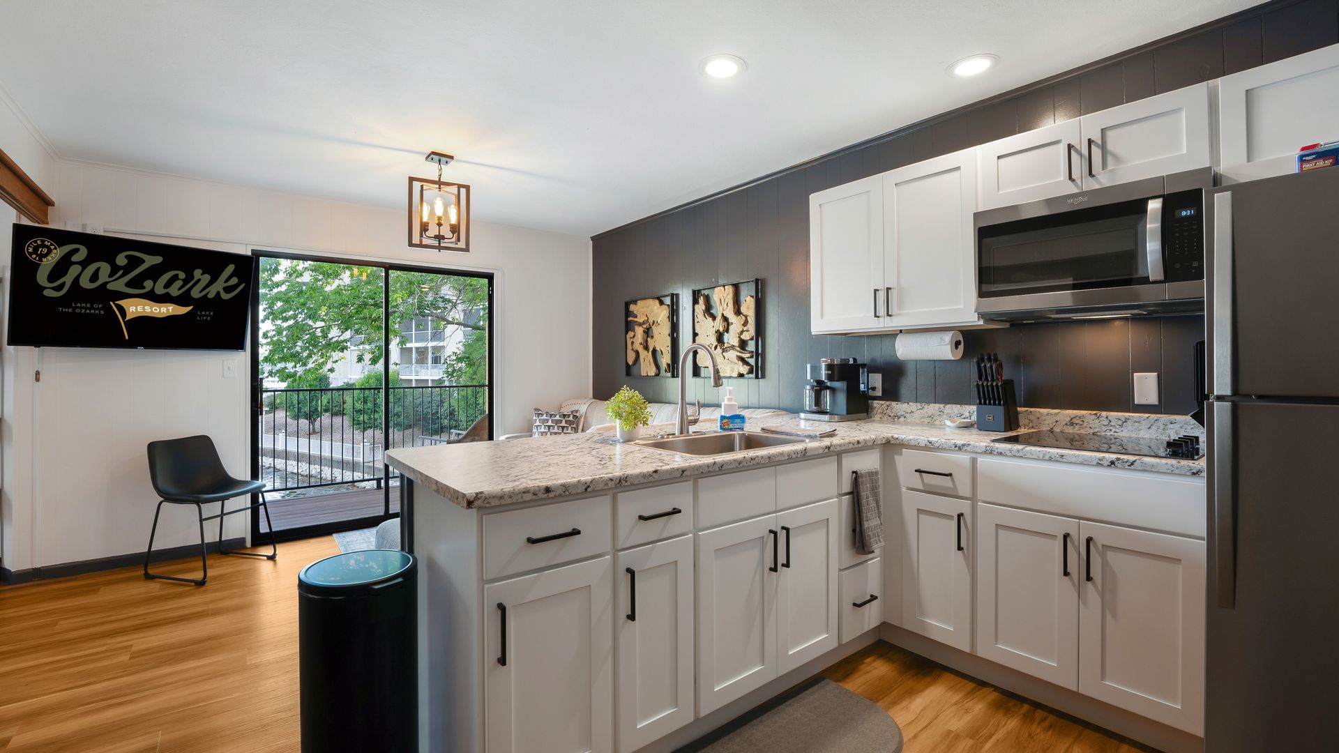 A kitchen with white cabinets and stainless steel appliances.