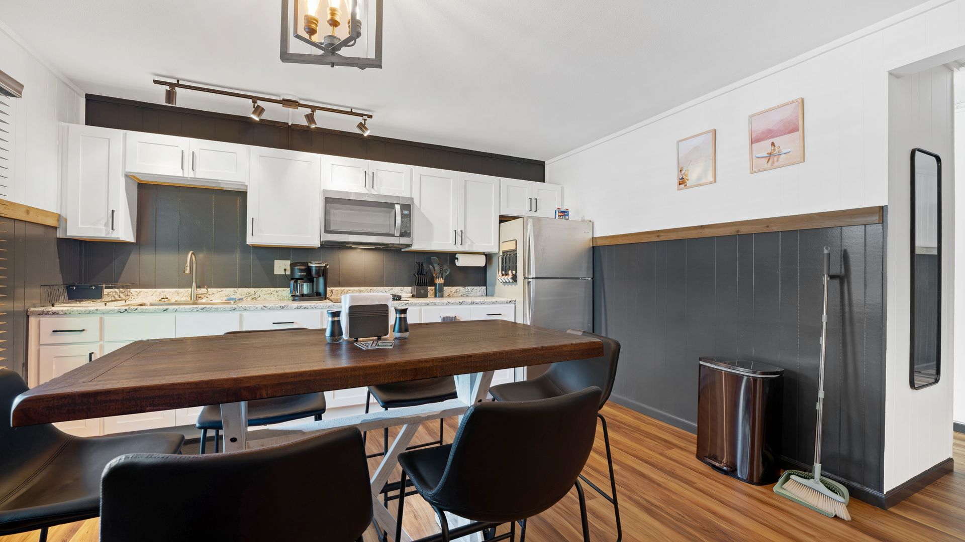 There is a dining table and chairs in the kitchen.