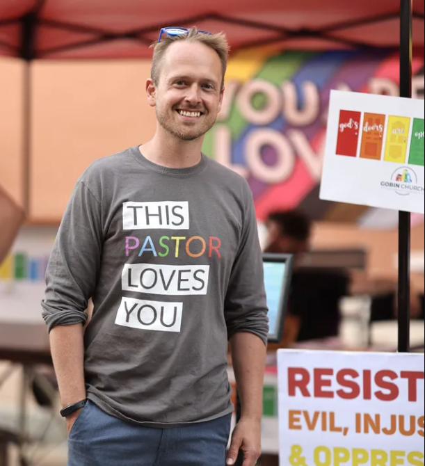 A man wearing a shirt that says this pastor loves you