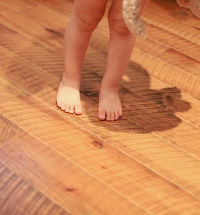 Child's feet on circle sawn hardwood floor