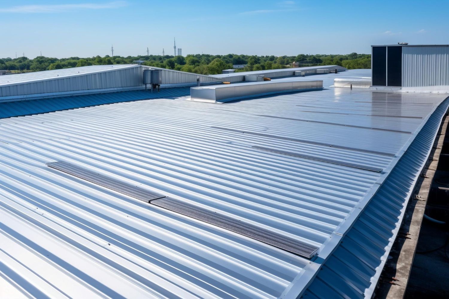 A metal roof of a building with a blue sky in the background.