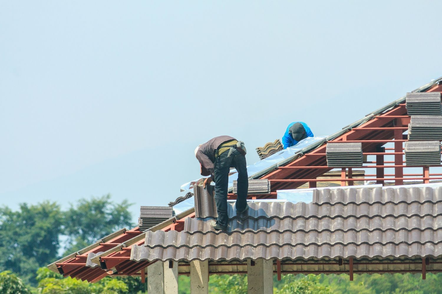 A man is working on the roof of a house.