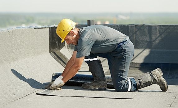 Worker repairs roof