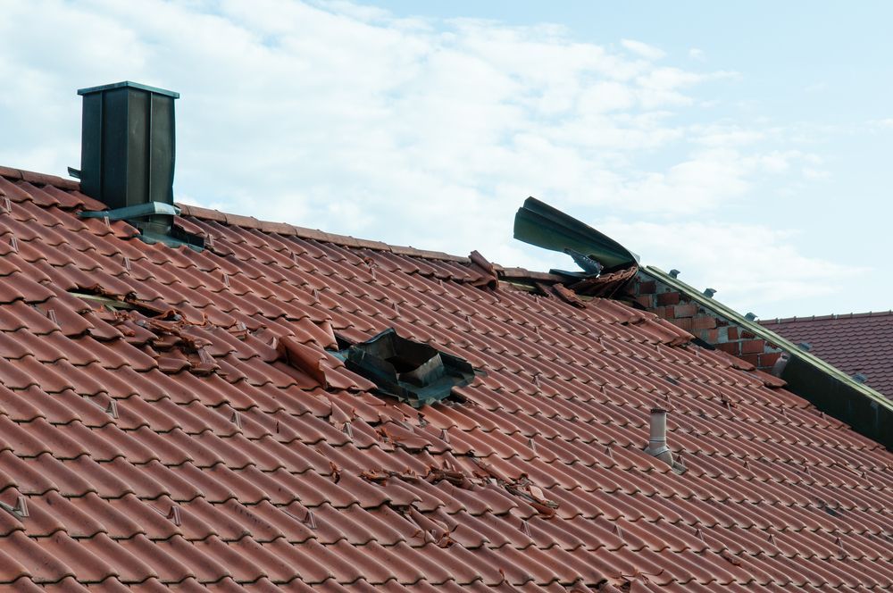 A roof with a chimney and a hole in it.