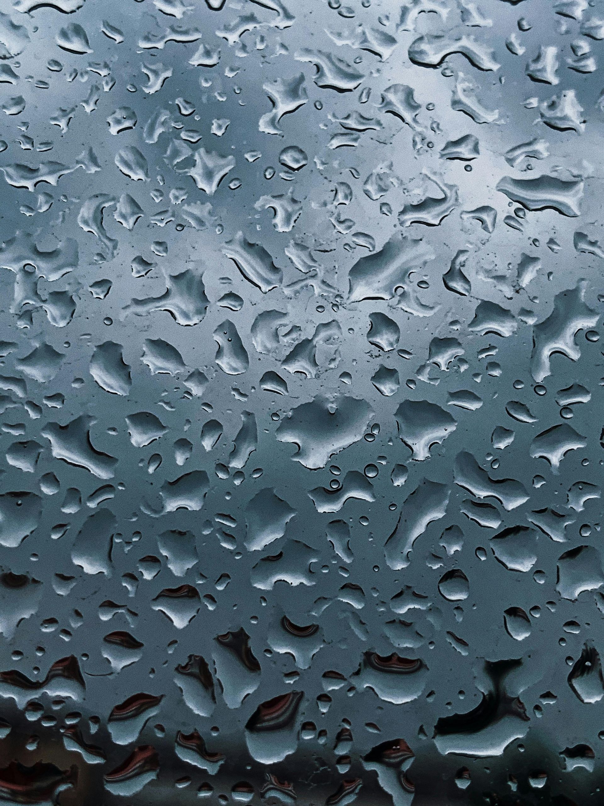 A close up of rain drops on a window
