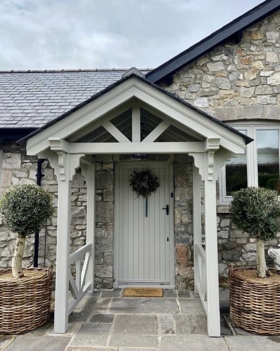 The English Porch Company elegant wooden porch on stone cottage