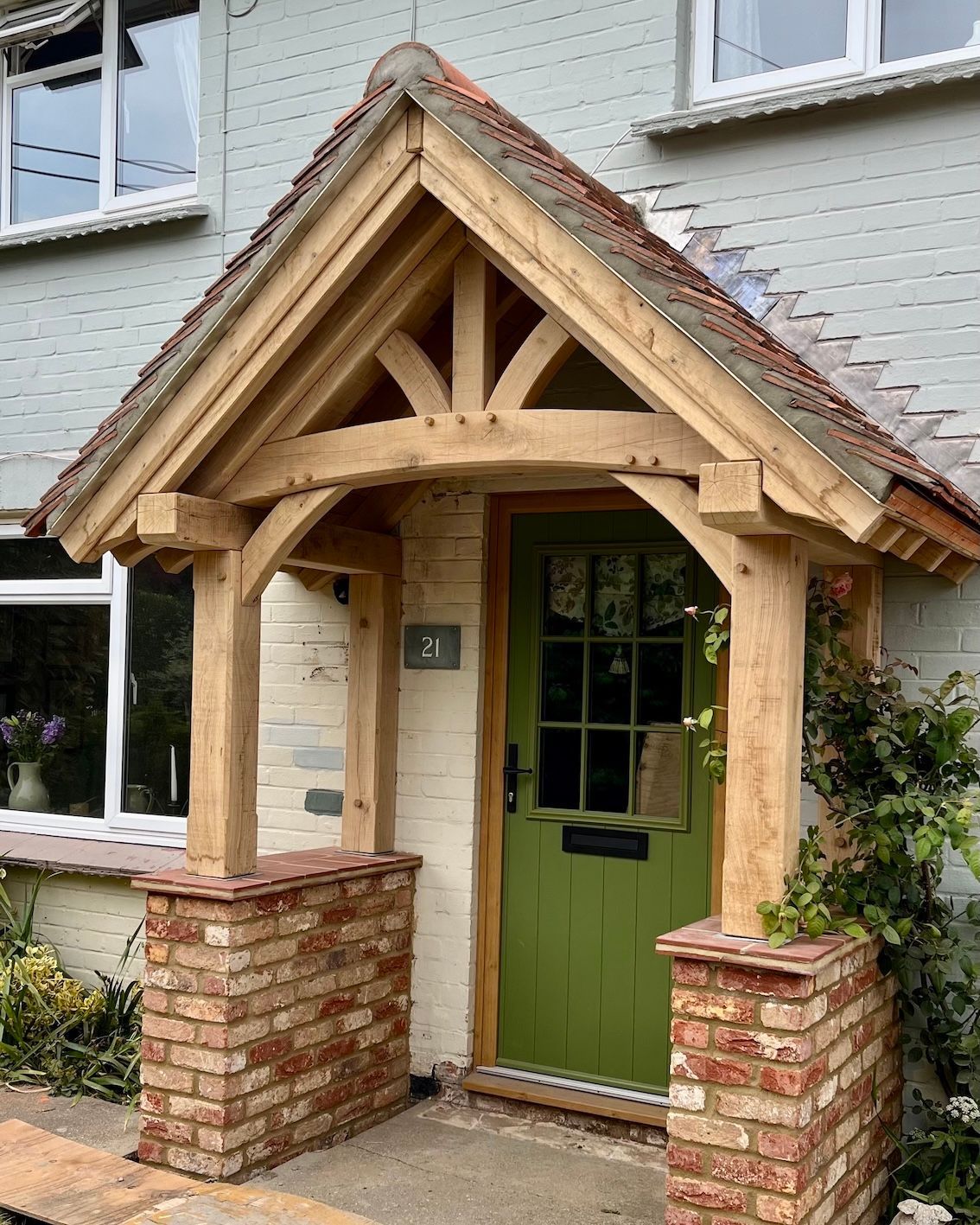 The English Porch Company elegant wooden porch on stone cottage