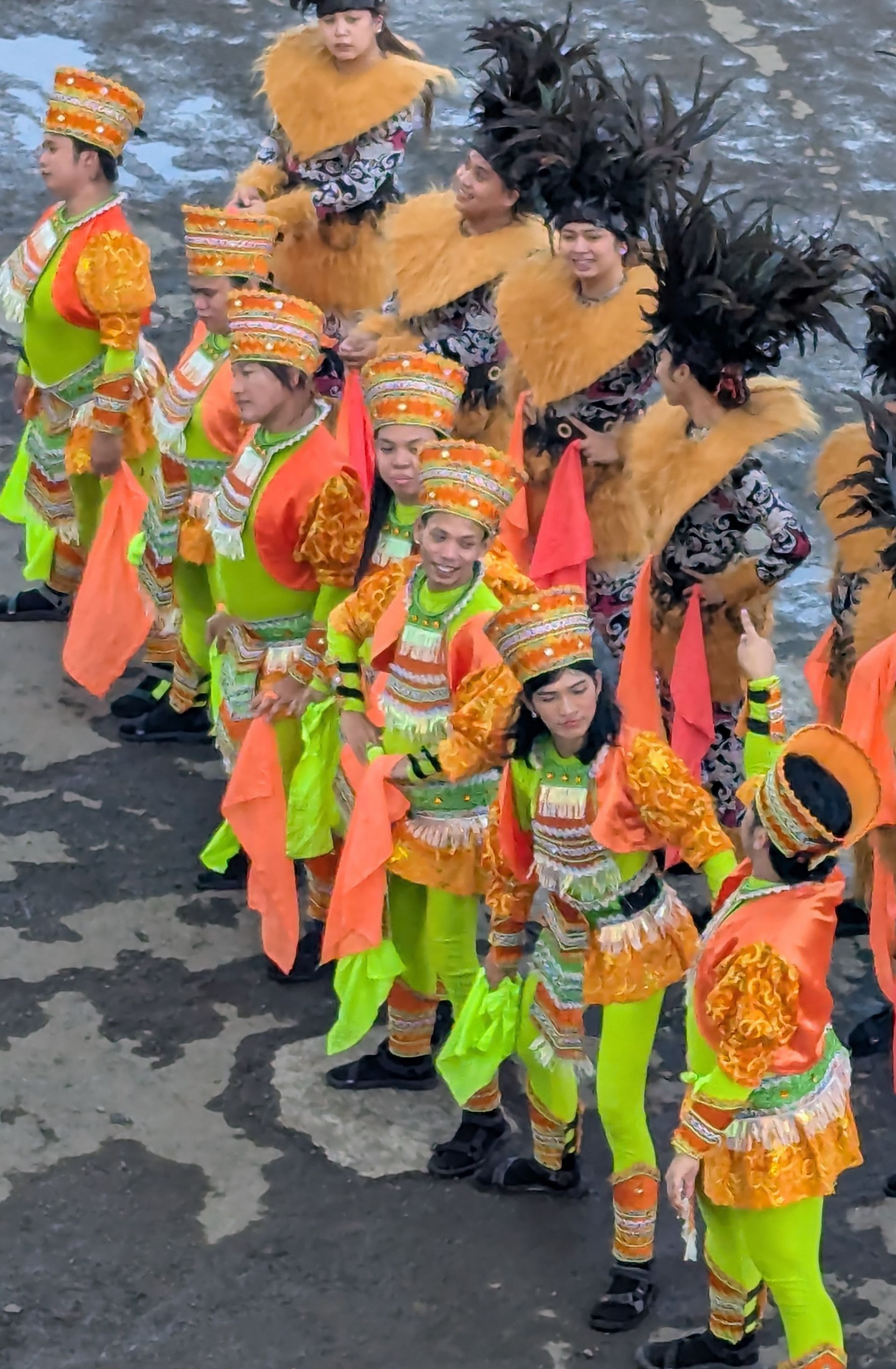 A group of people in colorful costumes are lined up, possibly performing.