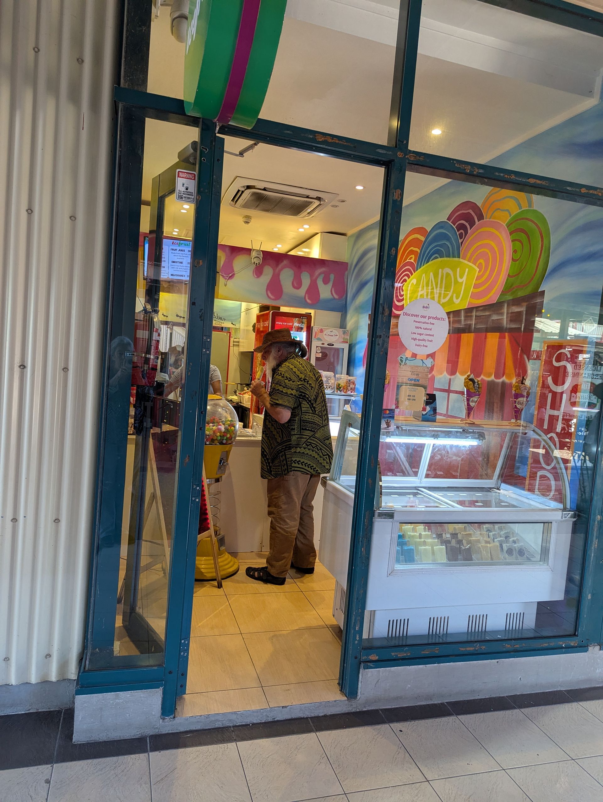 Two people paddle a wooden boat on a body of water.