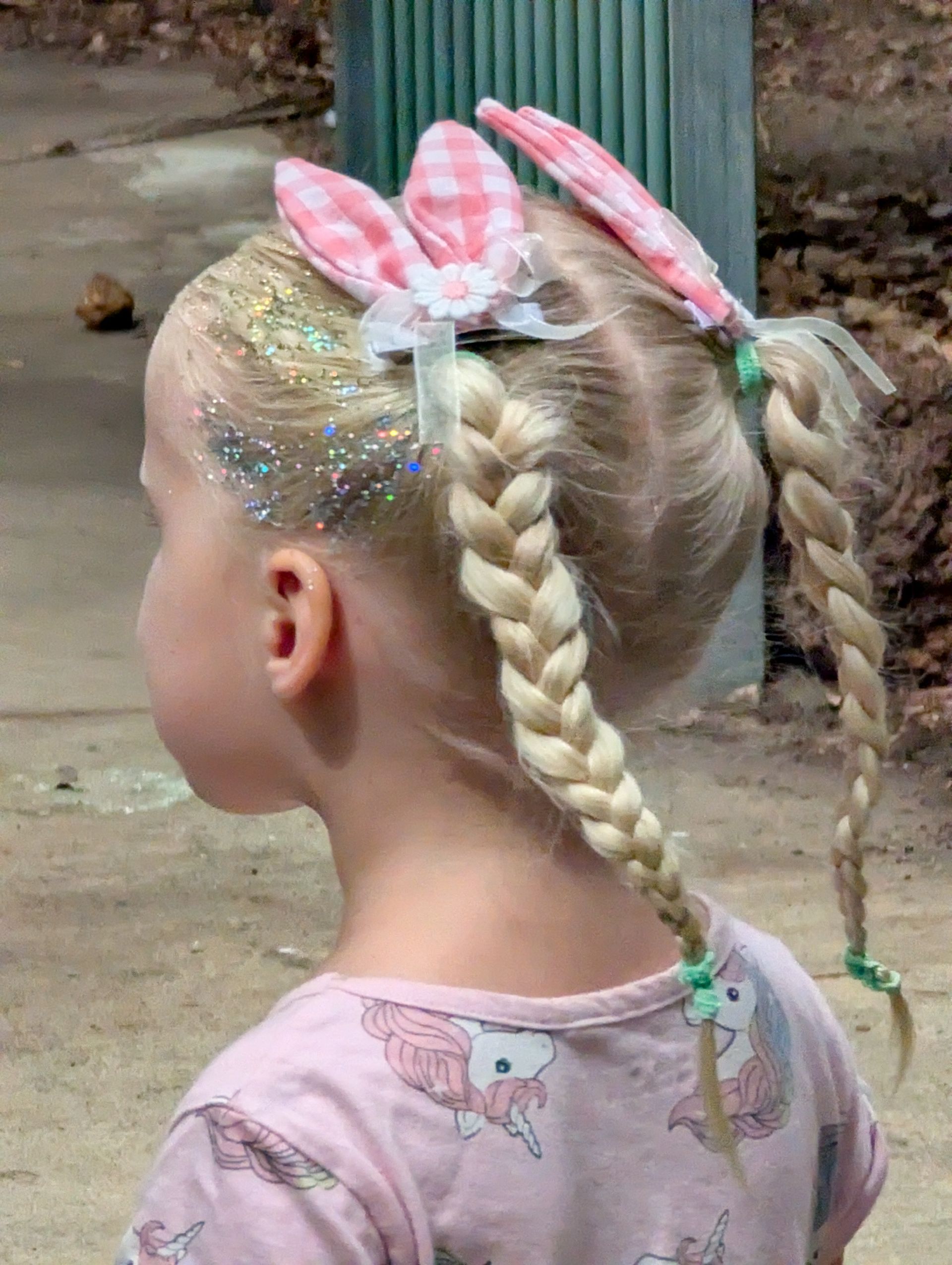 Two people paddle a wooden boat on a body of water.