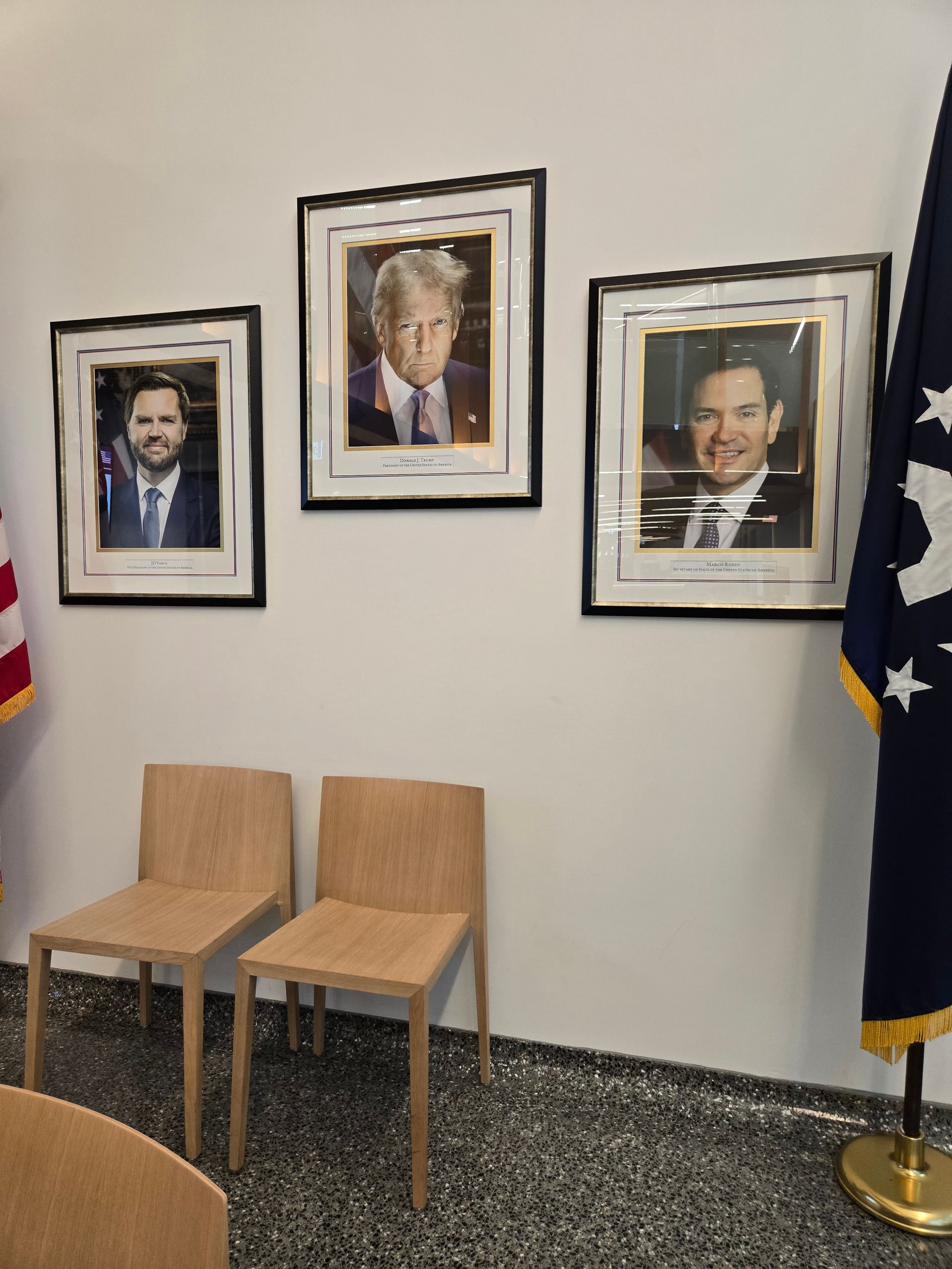 Two people paddle a wooden boat on a body of water.