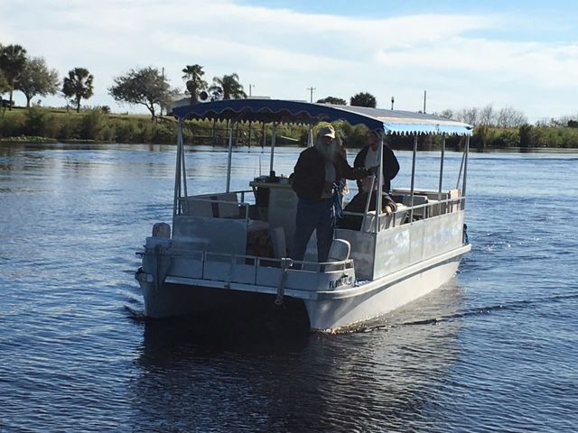 A boat with people on it is floating on a body of water