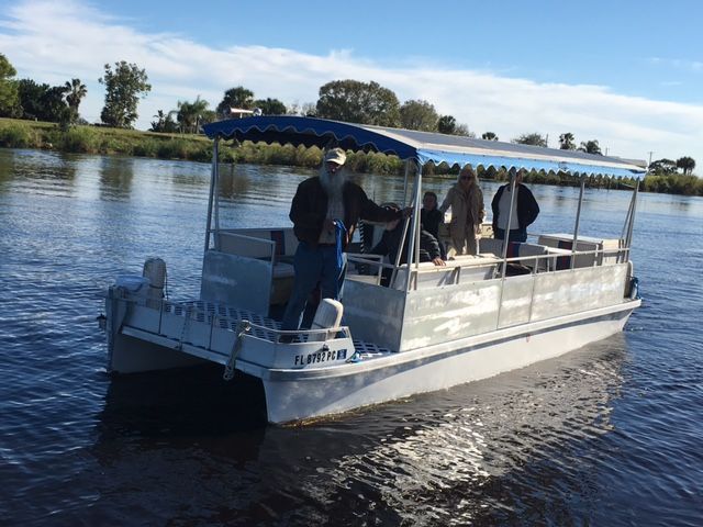 A boat with people on it is floating on a river.