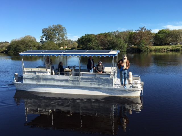 A boat with people on it is floating on a lake.