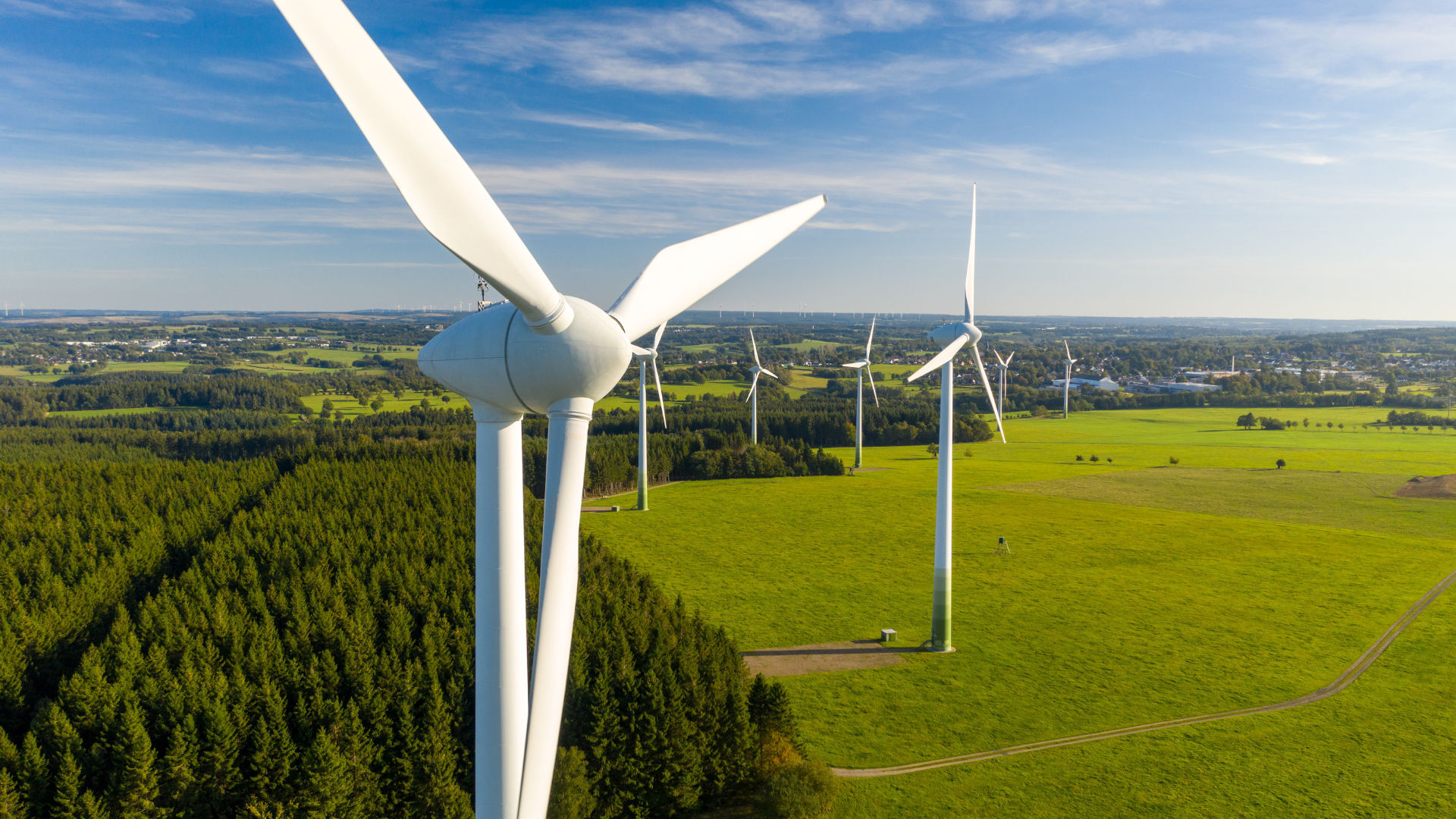 An aerial view of wind turbines in a field.