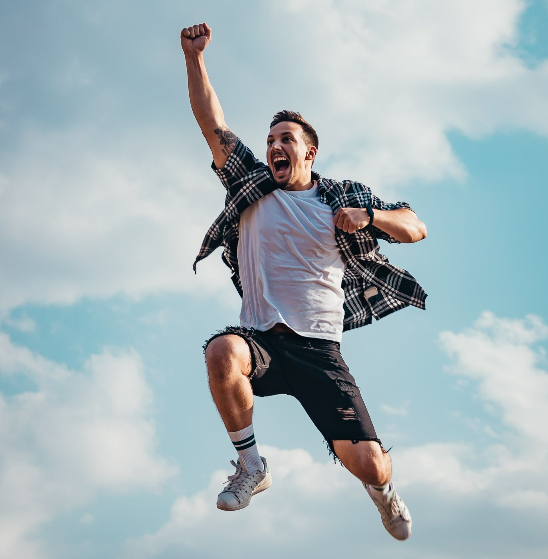 A man is jumping in the air with his fist in the air.