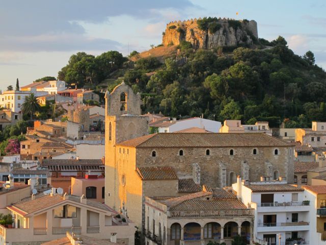 A city with a castle on top of a hill in the background