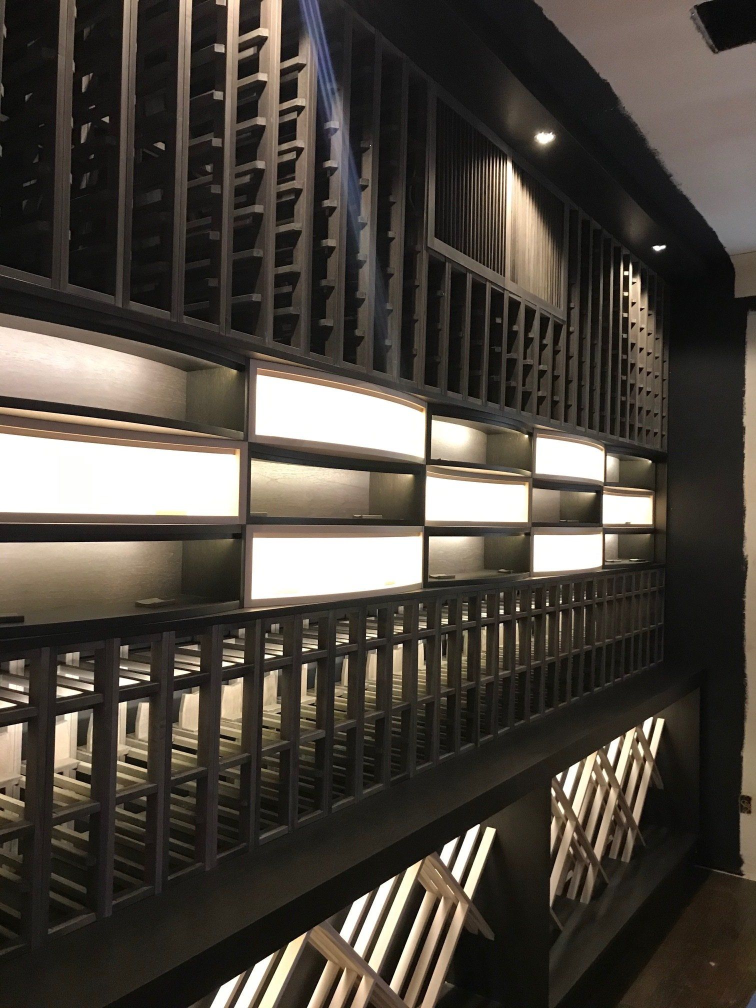 A large wine cellar with lots of shelves and lights