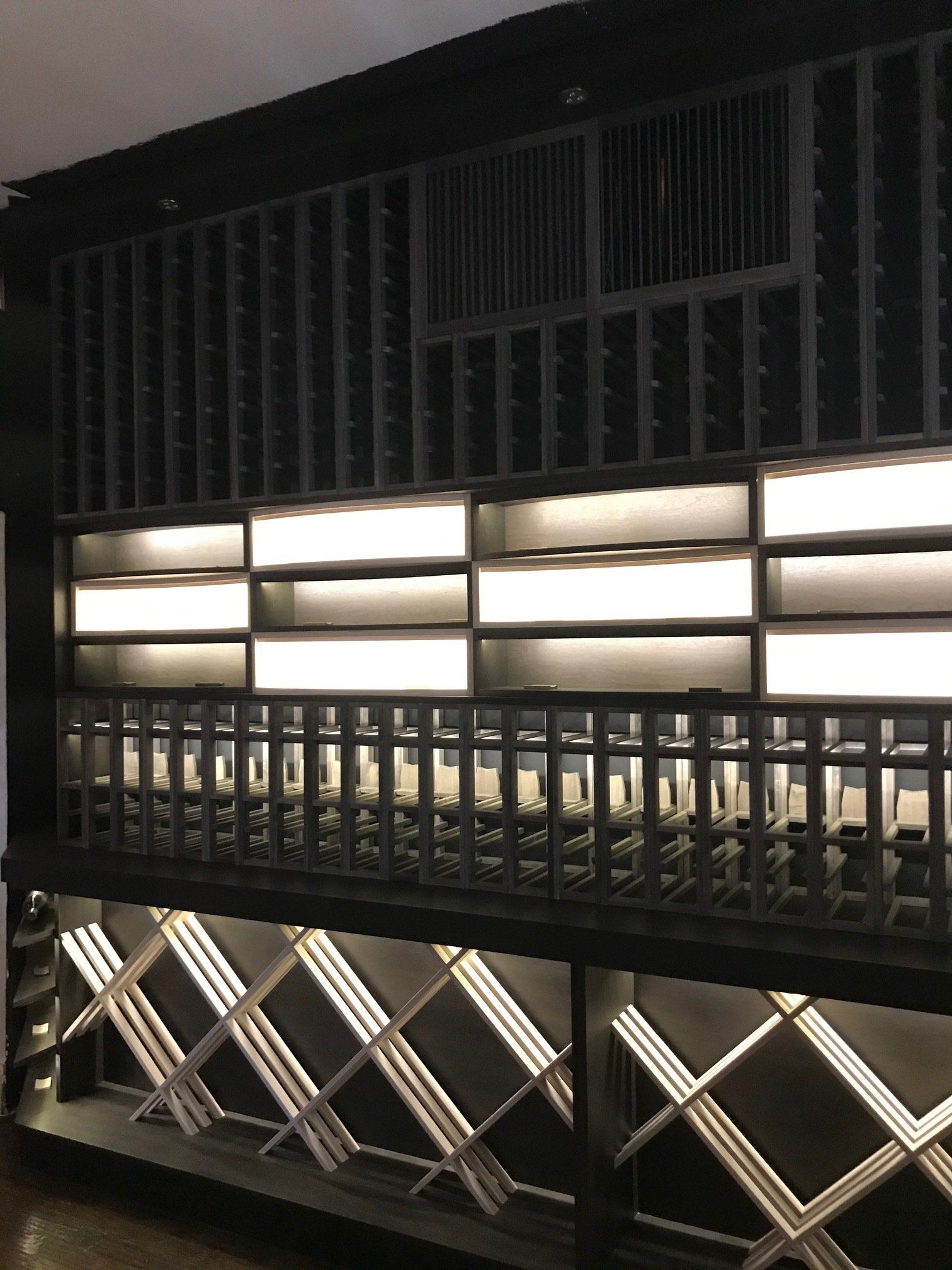 A wine cellar with lots of shelves and lights