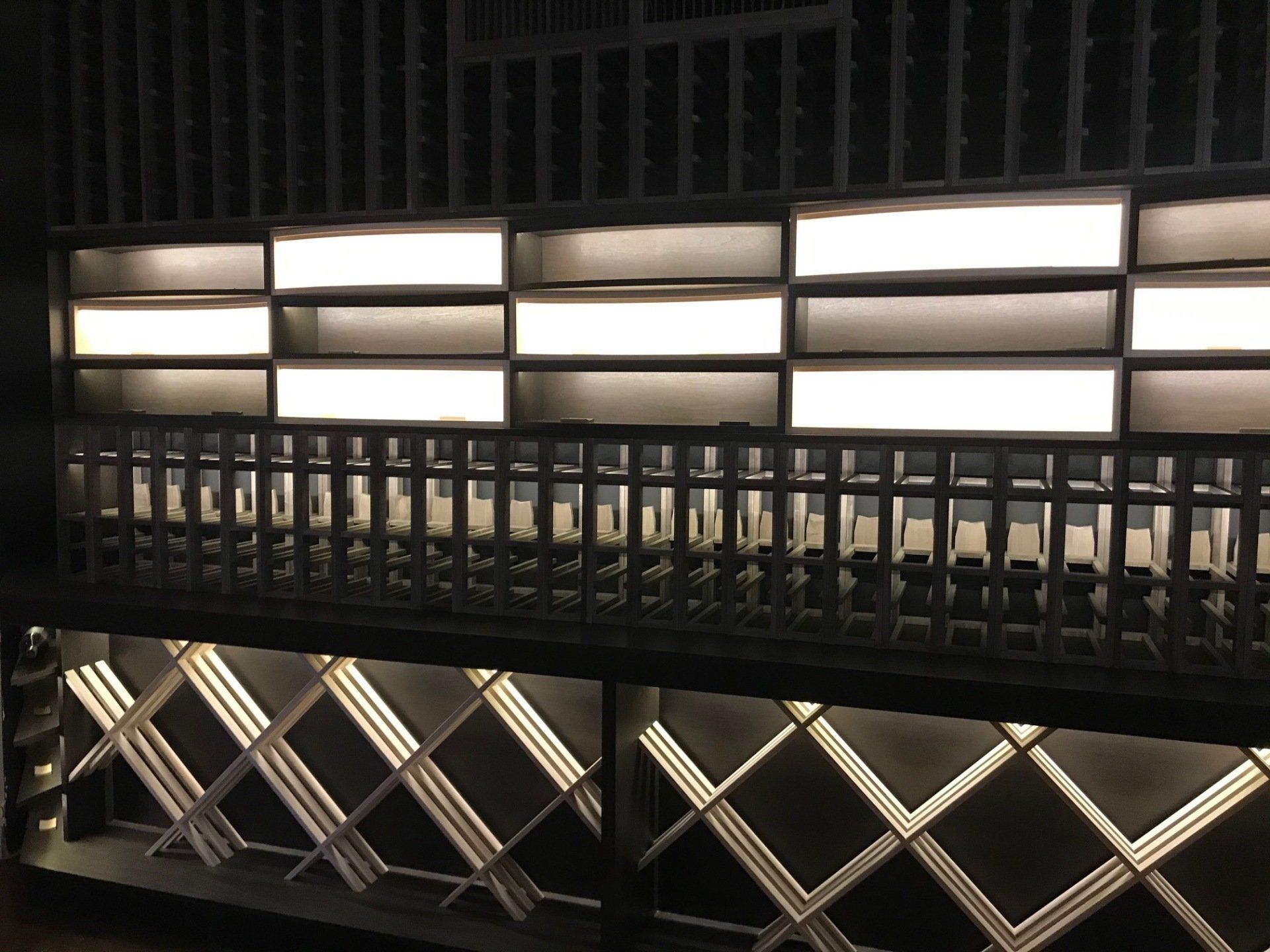 A row of shelves with lights on them in a dark room