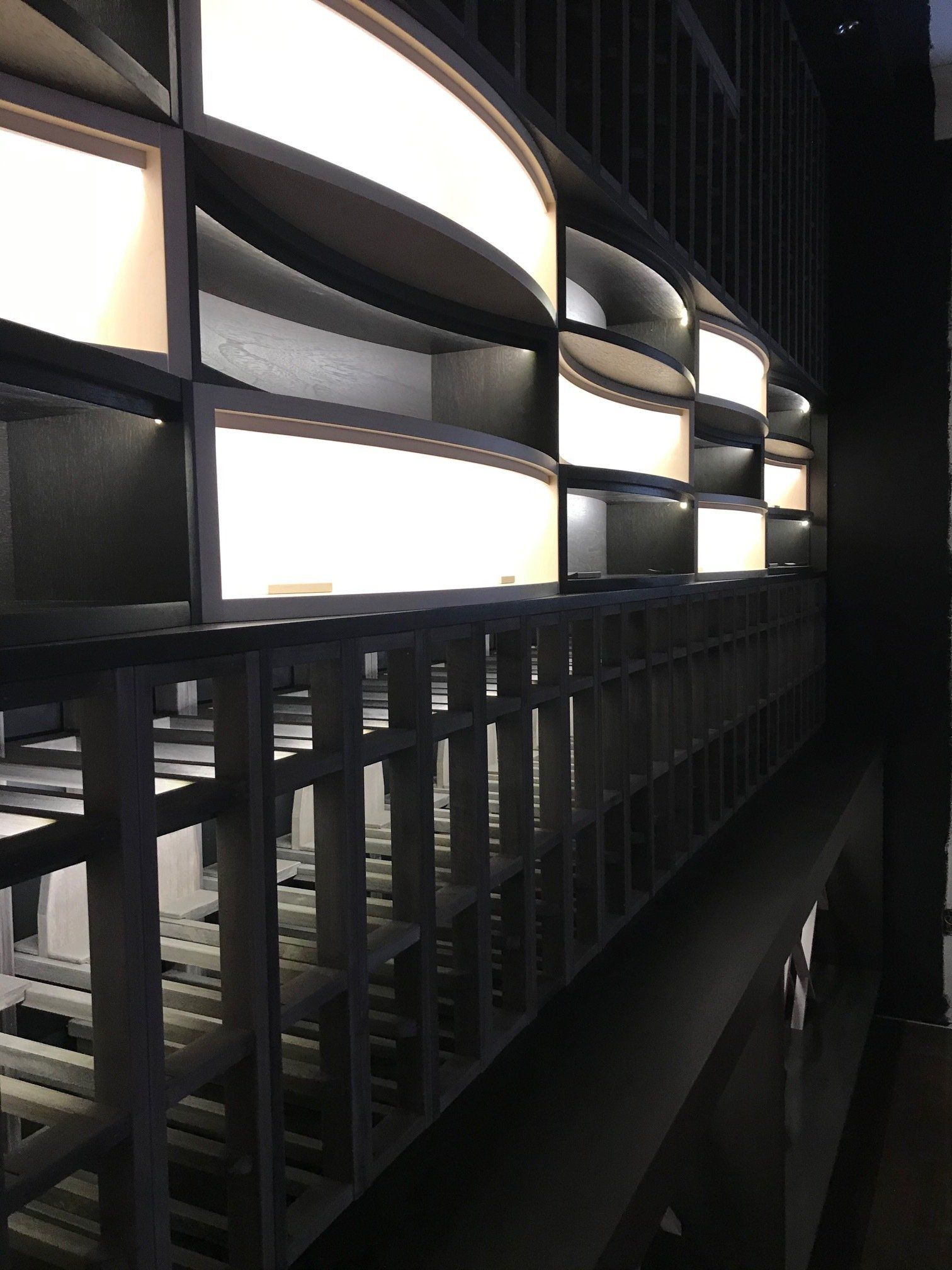 A dark room with a lot of shelves and lights