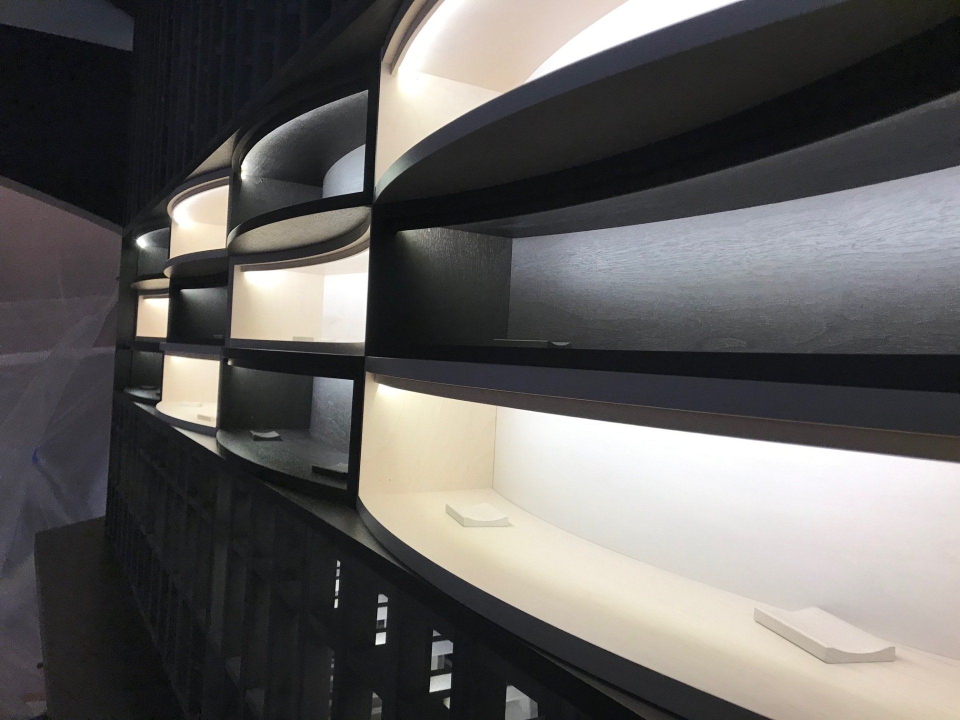 A row of curved shelves with lights on them